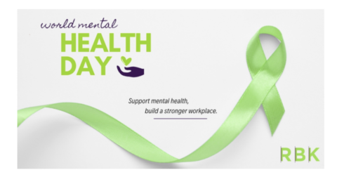 Green ribbon with text: “World Mental Health Day” and “Support mental health, build a stronger workplace.” A green ribbon curves across the image. The letters RBK appear in the bottom right corner.
